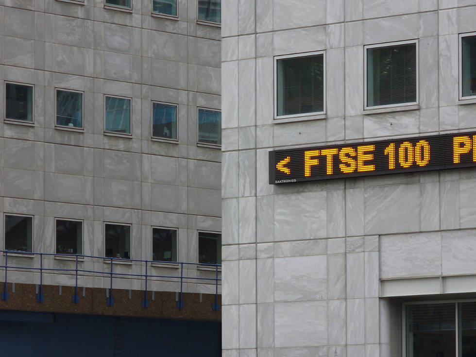 Financial news ticker on side of building