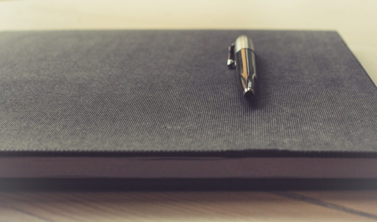 notebook and pen on a desk